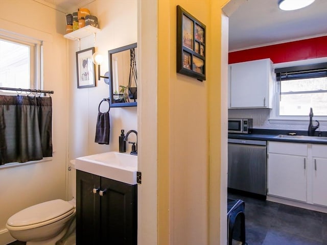 bathroom featuring toilet and vanity