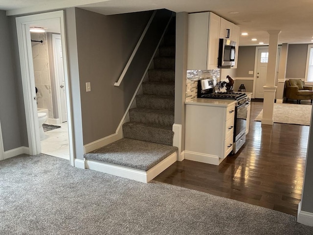 stairs with recessed lighting, wood finished floors, baseboards, and decorative columns