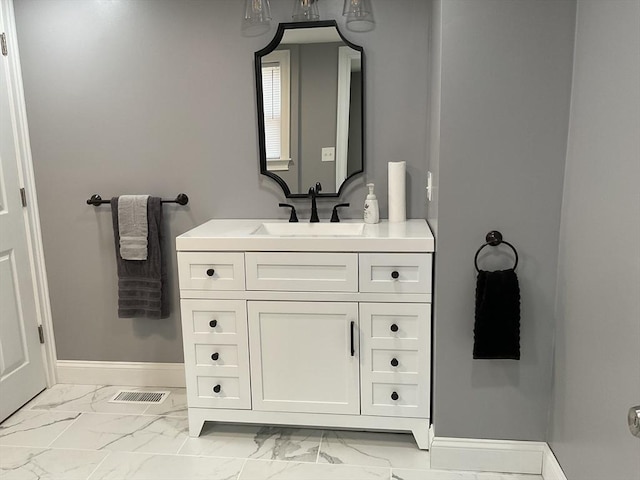 bathroom with visible vents, marble finish floor, vanity, and baseboards