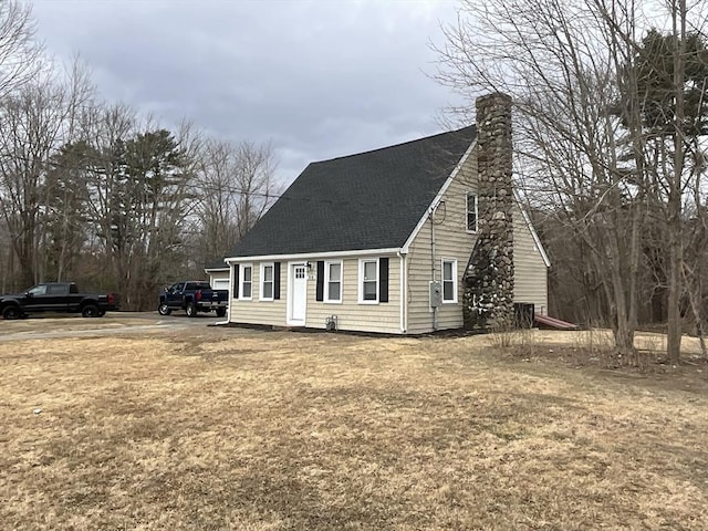 view of front of property featuring roof with shingles and a chimney