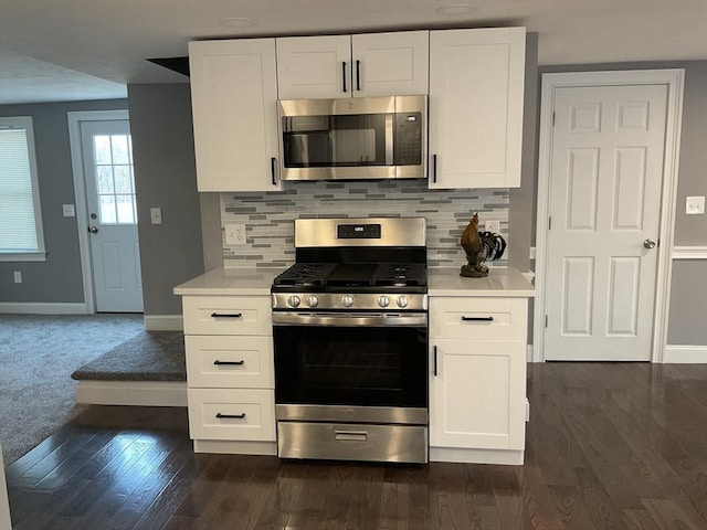 kitchen featuring tasteful backsplash, appliances with stainless steel finishes, white cabinets, and light countertops