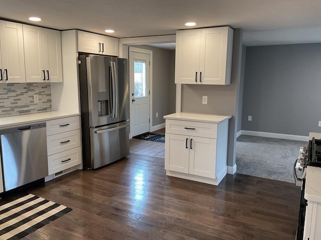 kitchen featuring baseboards, stainless steel appliances, light countertops, white cabinetry, and backsplash