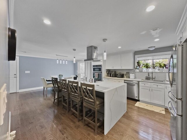 851 Forest St, North Andover, MA 01845 - kitchen with stainless steel appliances, island exhaust hood, a sink, a center island, and white cabinets