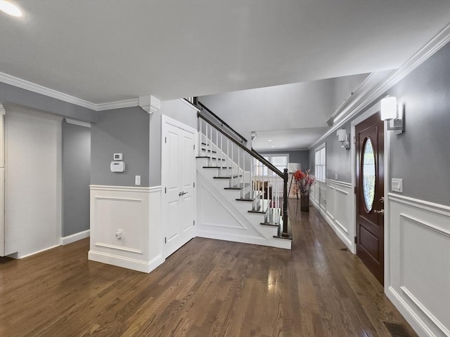 851 Forest St, North Andover, MA 01845 - foyer entrance featuring a decorative wall, stairway, crown molding, dark wood-style floors, and wainscoting