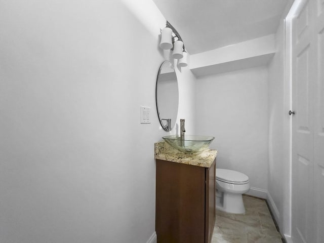 851 Forest St, North Andover, MA 01845 - bathroom featuring vanity, toilet, and baseboards