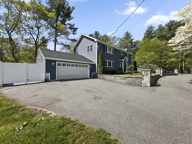 851 Forest St, North Andover, MA 01845 - view of front of house featuring asphalt driveway and a garage