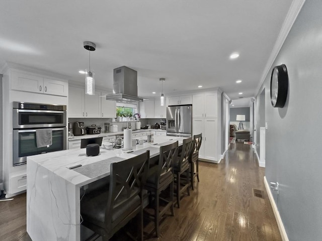 851 Forest St, North Andover, MA 01845 - kitchen with island range hood, appliances with stainless steel finishes, a center island, dark wood-style flooring, and ornamental molding