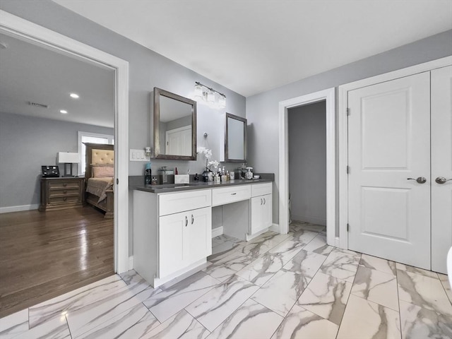851 Forest St, North Andover, MA 01845 - ensuite bathroom featuring double vanity, baseboards, recessed lighting, and marble look tiles