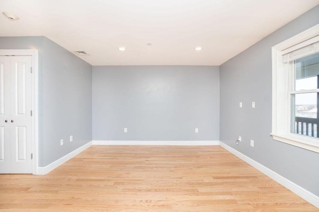 spare room with light wood-type flooring