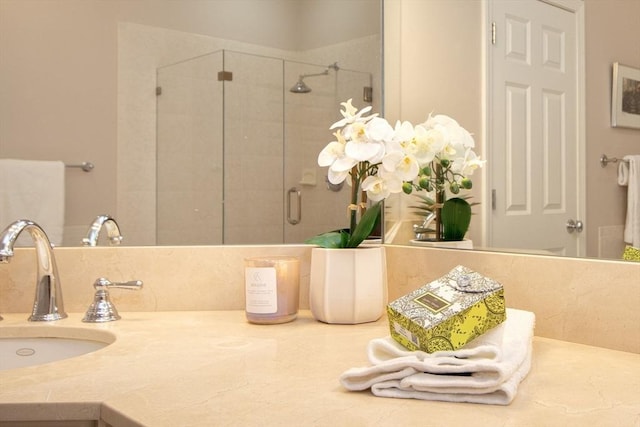 bathroom featuring vanity and an enclosed shower