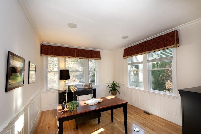 office space with light hardwood / wood-style floors and ornamental molding