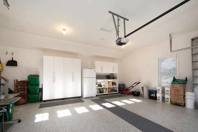 garage with white fridge and a garage door opener