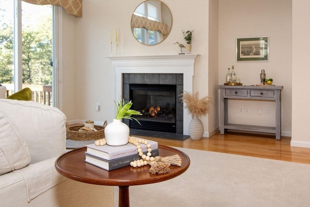 sitting room featuring hardwood / wood-style flooring, a healthy amount of sunlight, and a fireplace