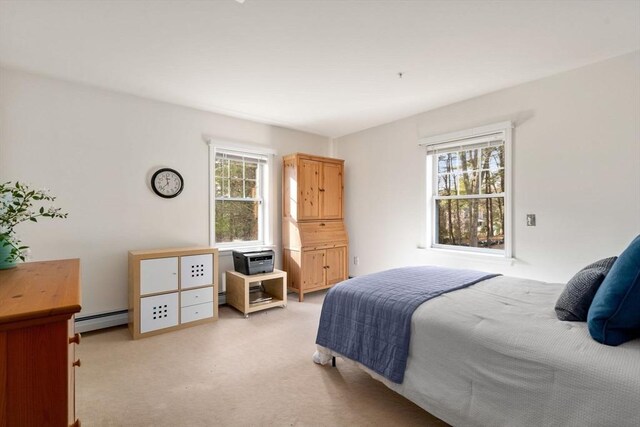 carpeted bedroom featuring baseboard heating