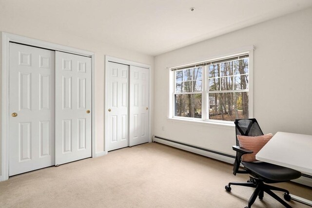 office space featuring baseboard heating and light carpet