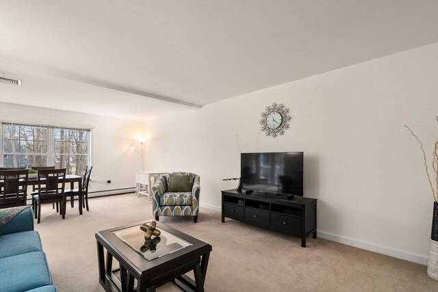 living room with beamed ceiling, light carpet, and a baseboard heating unit