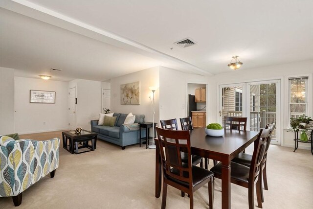 dining space featuring light colored carpet