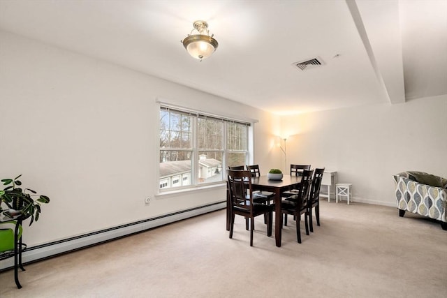 dining space featuring light carpet and a baseboard radiator