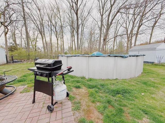 view of yard featuring an outdoor pool and fence