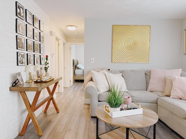 living area featuring attic access and light wood-style floors