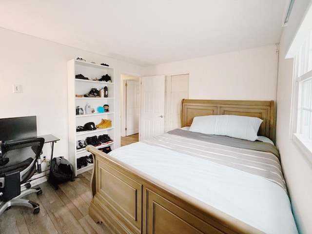 bedroom featuring light wood-style floors and a closet