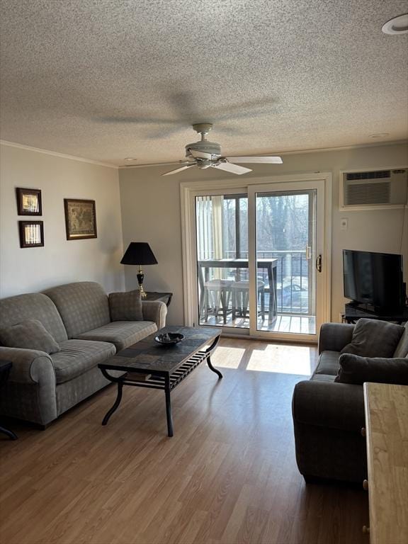 12 Candlewood Ln Unit 2-2, Dennis, MA 02639 - living area featuring a textured ceiling, wood finished floors, a ceiling fan, and a wall mounted AC