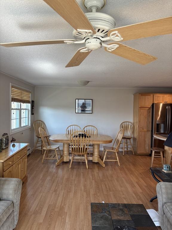 12 Candlewood Ln Unit 2-2, Dennis, MA 02639 - dining space with baseboards, ceiling fan, light wood-style floors, and a textured ceiling
