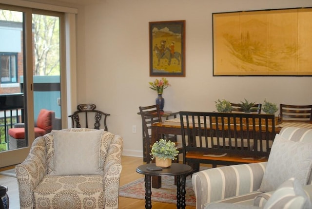 sitting room with baseboards and wood finished floors