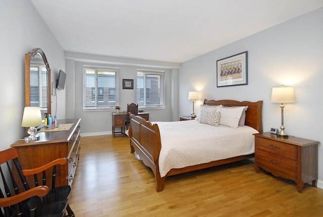 bedroom with baseboards and light wood-style flooring