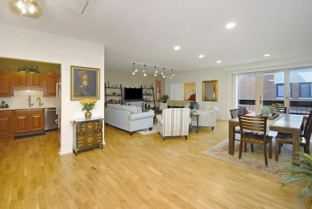 living area featuring recessed lighting, rail lighting, and light wood-type flooring