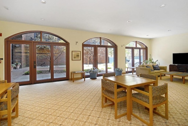 dining space with recessed lighting, light carpet, and french doors