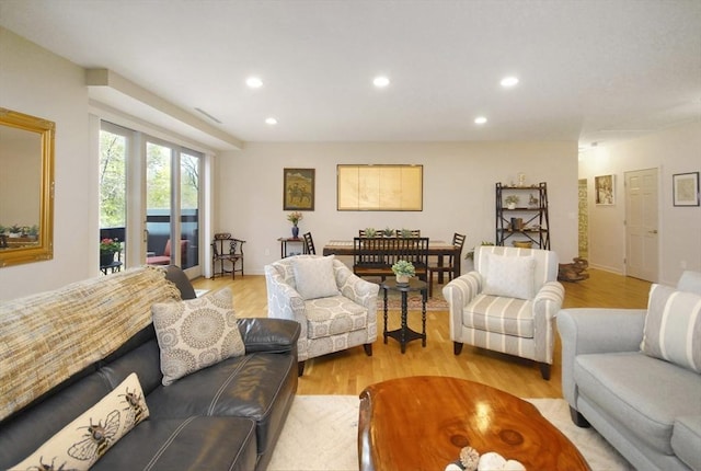 living room featuring recessed lighting, visible vents, and light wood finished floors