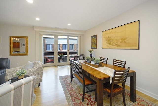 dining space with recessed lighting, baseboards, and light wood finished floors