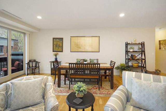 living room with recessed lighting, baseboards, and wood finished floors