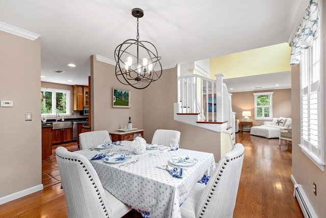 7 Lauras Ln, Marshfield, MA 02050 - dining room featuring a baseboard heating unit, a chandelier, healthy amount of natural light, stairs, and ornamental molding