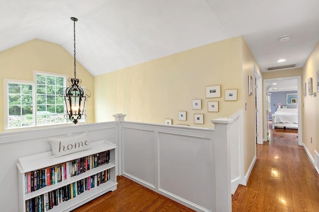 7 Lauras Ln, Marshfield, MA 02050 - hall with an upstairs landing, wood finished floors, a chandelier, vaulted ceiling, and a wainscoted wall