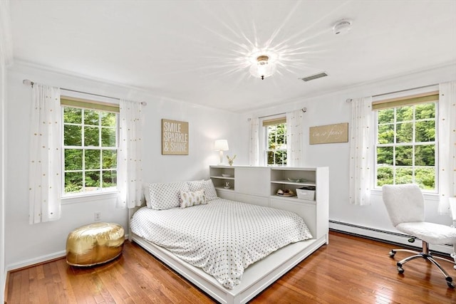 7 Lauras Ln, Marshfield, MA 02050 - bedroom featuring wood-type flooring, multiple windows, and a baseboard heating unit