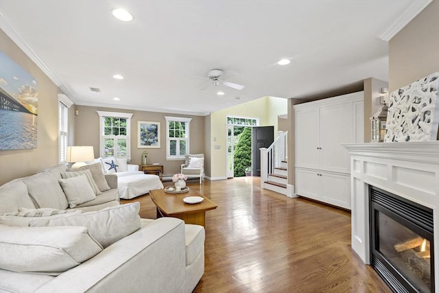 7 Lauras Ln, Marshfield, MA 02050 - living room with ornamental molding, a glass covered fireplace, a ceiling fan, wood finished floors, and recessed lighting