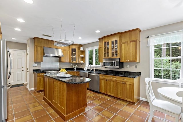 7 Lauras Ln, Marshfield, MA 02050 - kitchen featuring stainless steel appliances, wall chimney exhaust hood, recessed lighting, a kitchen island, and tile patterned flooring