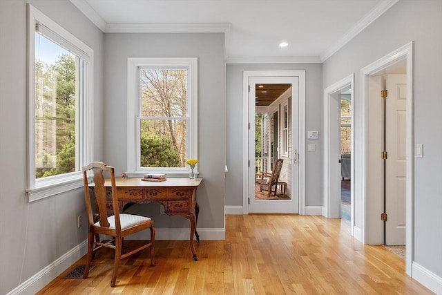 doorway to outside with baseboards, visible vents, light wood finished floors, and a wealth of natural light