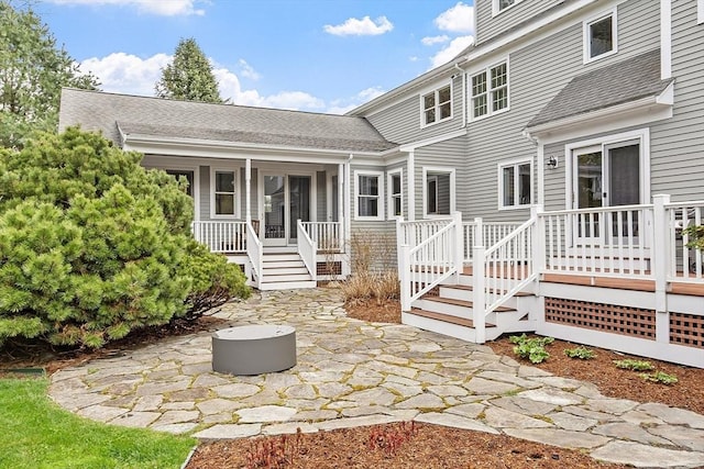 back of house featuring stairs, a patio area, and roof with shingles