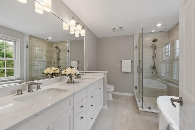 bathroom featuring a sink, baseboards, a stall shower, and double vanity