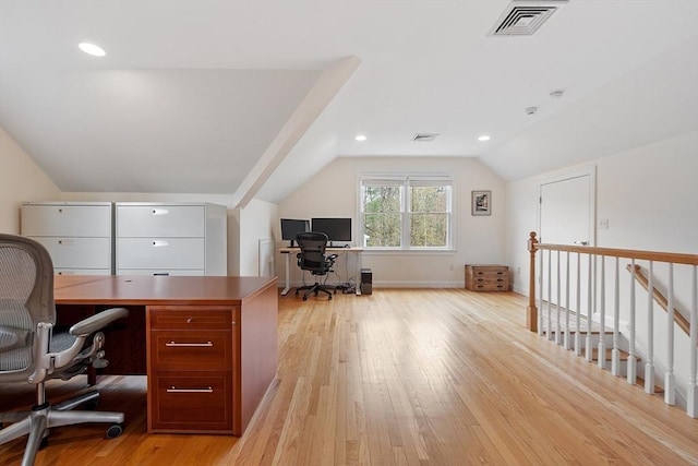 office with visible vents, lofted ceiling, and light wood-style floors