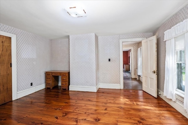 empty room featuring dark hardwood / wood-style flooring