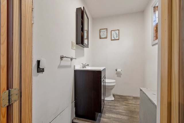 bathroom featuring hardwood / wood-style floors, vanity, and toilet