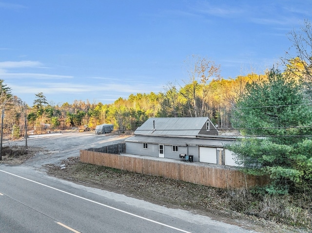 exterior space featuring a garage and solar panels