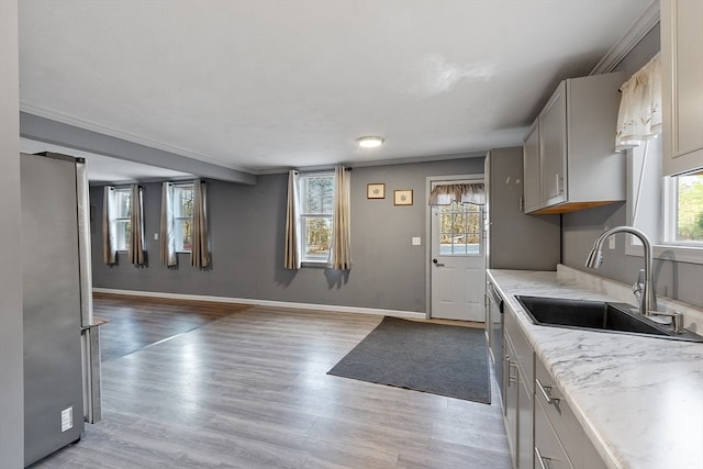 kitchen featuring stainless steel fridge, plenty of natural light, sink, and light hardwood / wood-style flooring