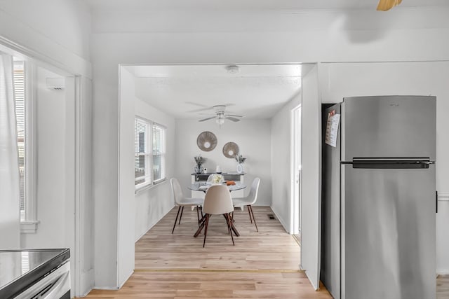 dining area featuring ceiling fan and light wood-type flooring