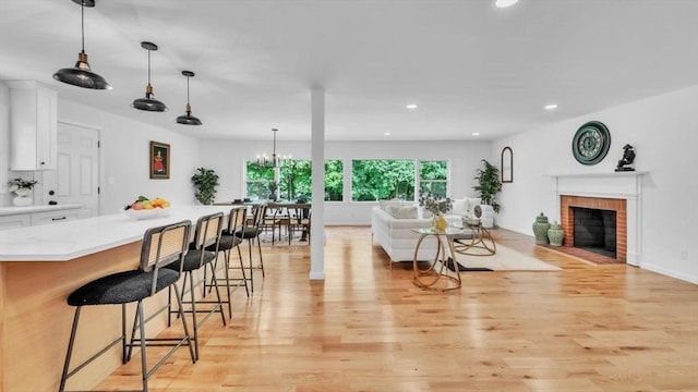 90 Fox Farms Rd, Northampton, MA 01062 - living room with light wood finished floors, recessed lighting, and a brick fireplace