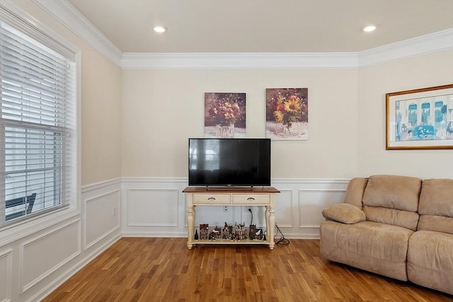 unfurnished living room with ornamental molding, recessed lighting, wood finished floors, and a decorative wall